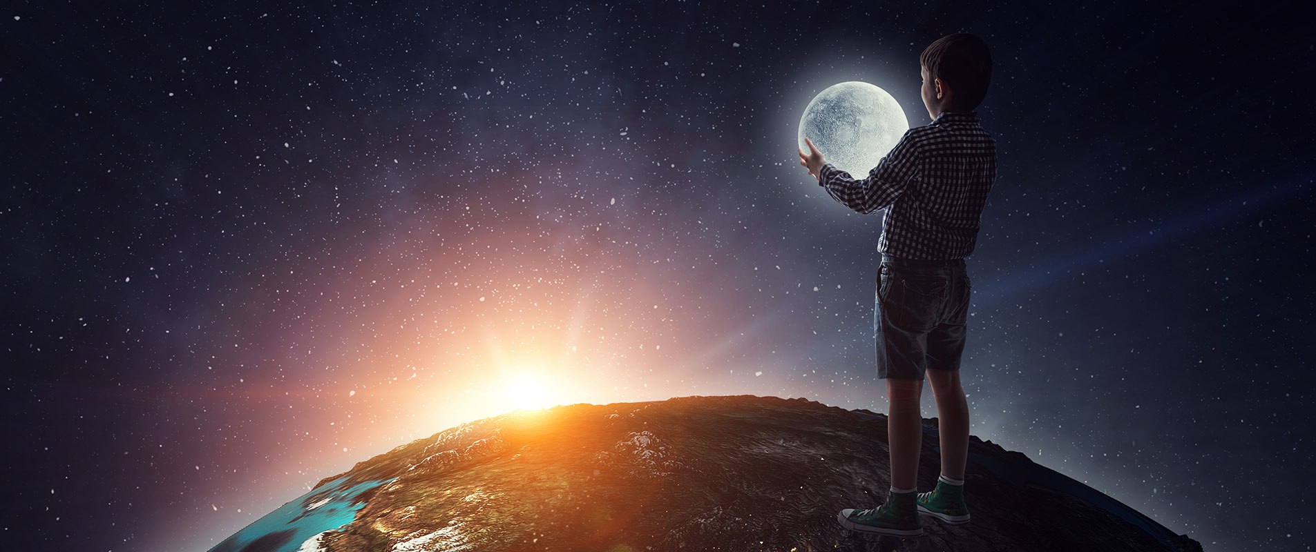 Concept image of boy standing on earth, holding moon